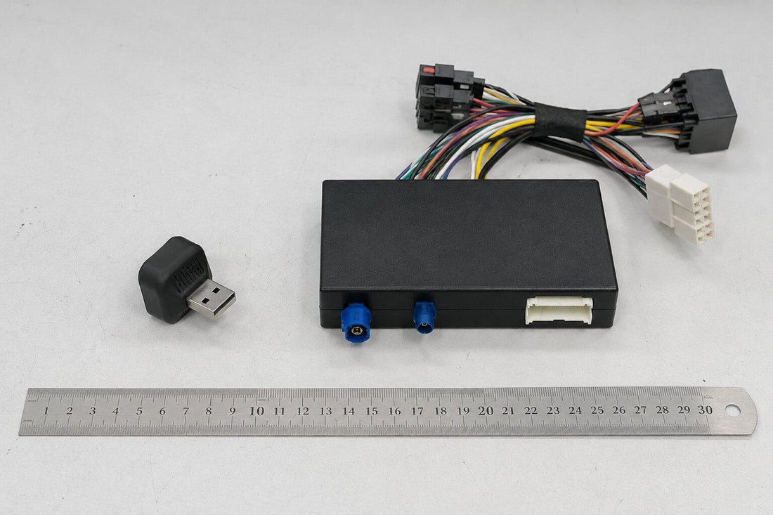 CarPlay wireless adapter next to a retrofit module