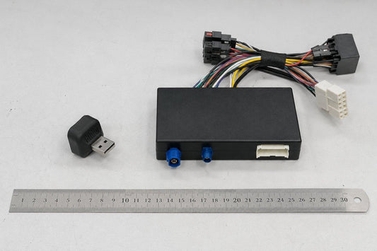 CarPlay wireless adapter next to a retrofit module